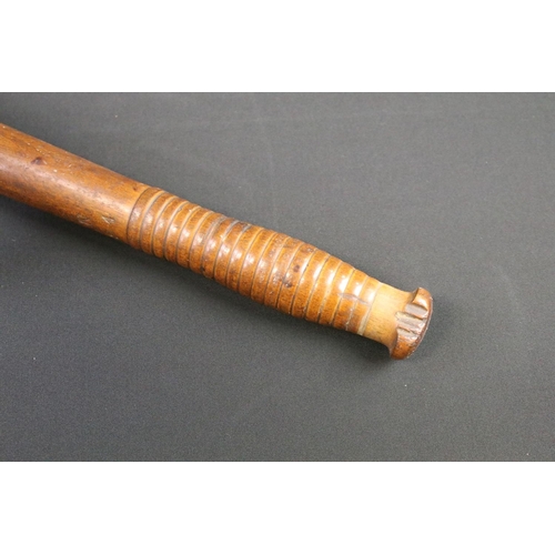 128 - A British World war Two War Department issued wooden truncheon, marked WD together with the broad ar... 