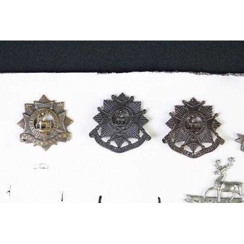 91 - A collection of mainly British military cap and collar badges to include officers examples.