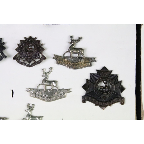 91 - A collection of mainly British military cap and collar badges to include officers examples.