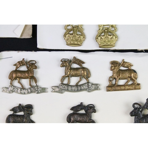 91 - A collection of mainly British military cap and collar badges to include officers examples.