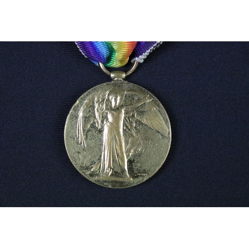 98 - A British full size World War One medal group of three to include the Victory Medal, the 1914-1918 B... 