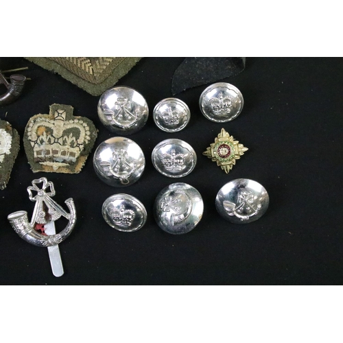 226 - A small collection of mainly British military badges, buttons and cloth patches.