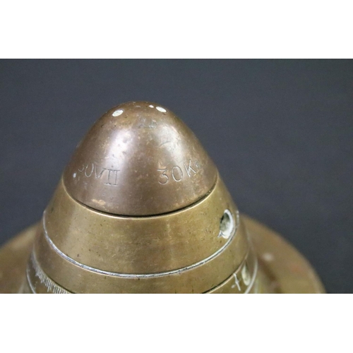 227 - A World War One trench art paper weight made from an artillery fuse and the base of an 18lb shell ca... 