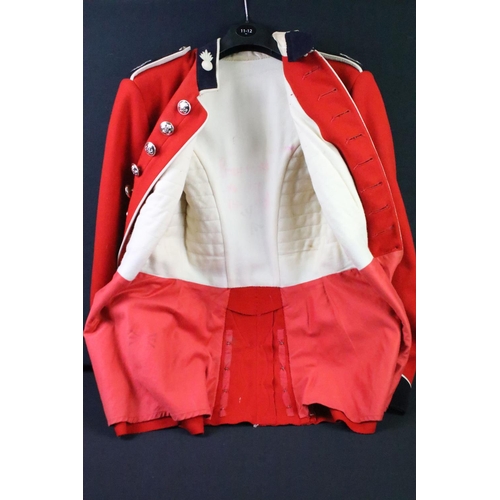 231 - A British military Grenadier Guards tunic complete with Queens crown  buttons and badges.