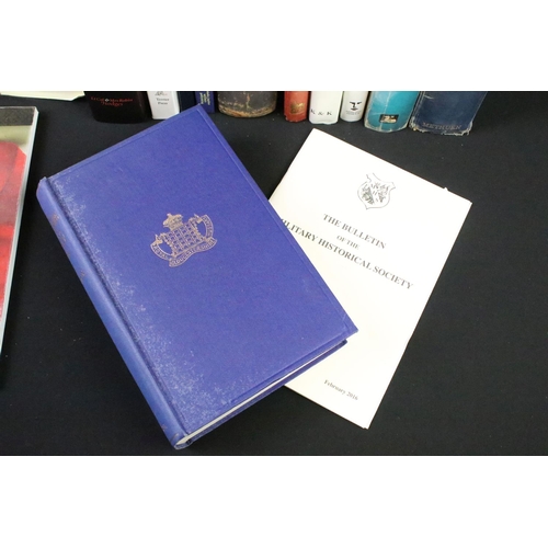234 - A large collection of military reference books to include Badge, Button, Medal and sword examples.