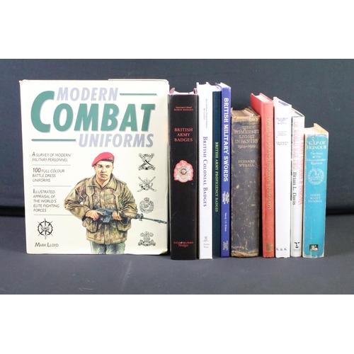 234 - A large collection of military reference books to include Badge, Button, Medal and sword examples.