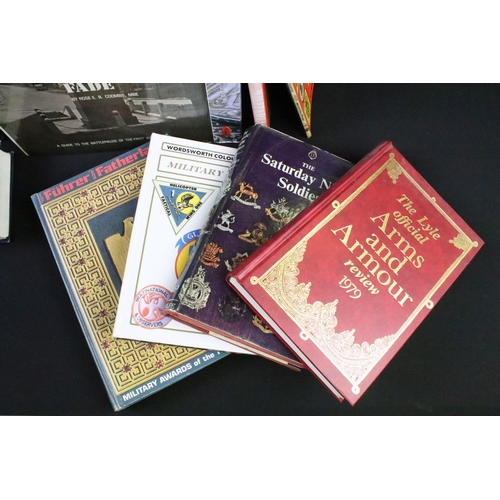 239 - A large collection of military reference books to include Badge, Uniform and World War Two examples.