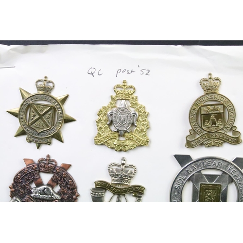 34 - A collection of Canadian Military Queens crown cap badges to include the West Nova Scotia Regiment, ... 