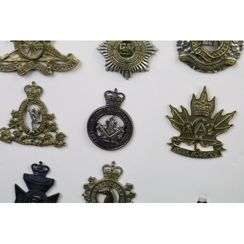 35 - A collection of Canadian Military Queens crown cap badges to include The Canadian Officers Training ... 