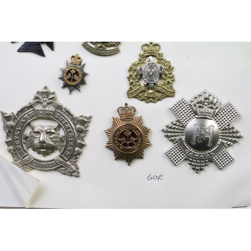 35 - A collection of Canadian Military Queens crown cap badges to include The Canadian Officers Training ... 