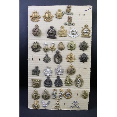 41 - A collection of British military regimental cap and collar badges to include the Army Service Corps,... 