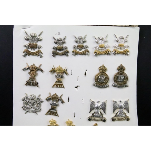 43 - A collection of British military regimental cap and collar badges to include the Devonshire regiment... 