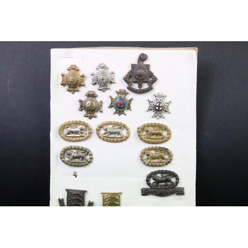 43 - A collection of British military regimental cap and collar badges to include the Devonshire regiment... 