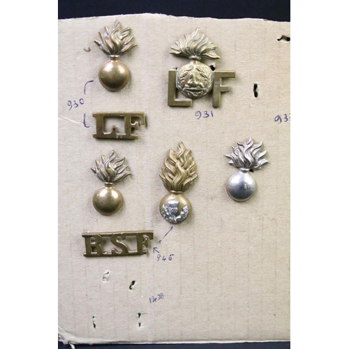 44 - A collection of British military regimental cap and collar badges to include the Somerset Light Infa... 