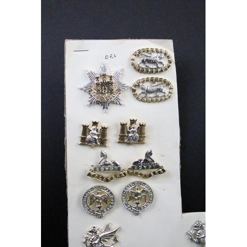 44 - A collection of British military regimental cap and collar badges to include the Somerset Light Infa... 