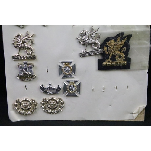 44 - A collection of British military regimental cap and collar badges to include the Somerset Light Infa... 