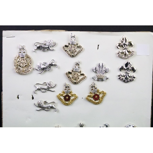 44 - A collection of British military regimental cap and collar badges to include the Somerset Light Infa... 