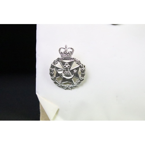 45 - A collection of British military regimental cap and collar badges to include the Royal Scots Regimen... 