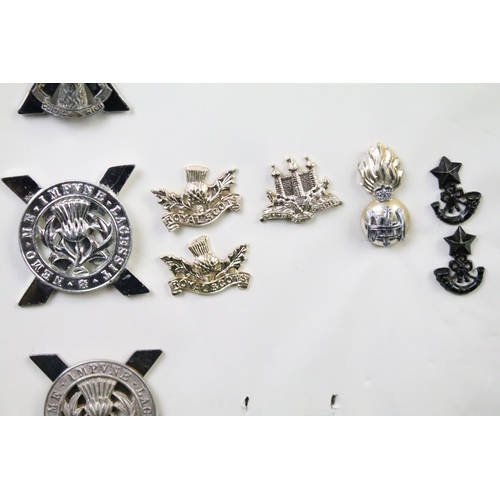 45 - A collection of British military regimental cap and collar badges to include the Royal Scots Regimen... 