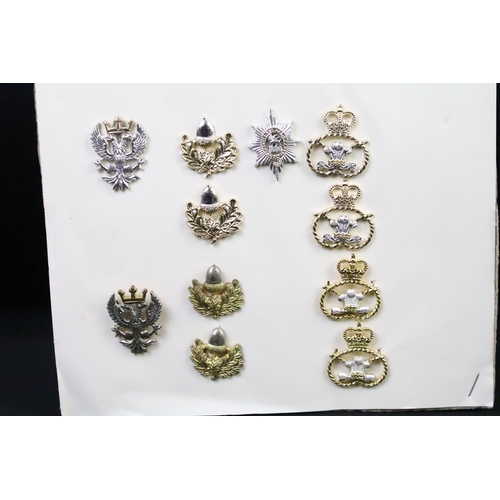 45 - A collection of British military regimental cap and collar badges to include the Royal Scots Regimen... 