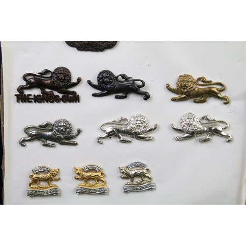 46 - A collection of British military regimental cap and collar badges to include the Lincolnshire regime... 