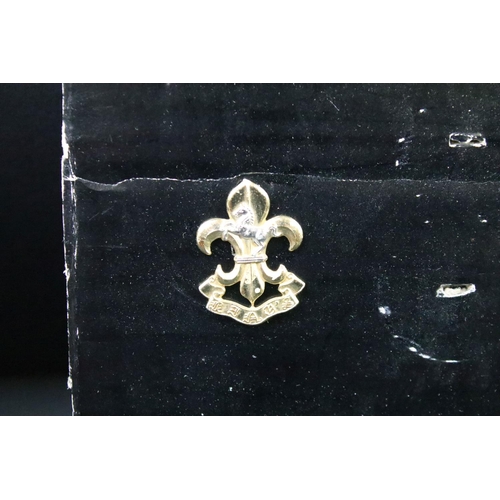 46 - A collection of British military regimental cap and collar badges to include the Lincolnshire regime... 