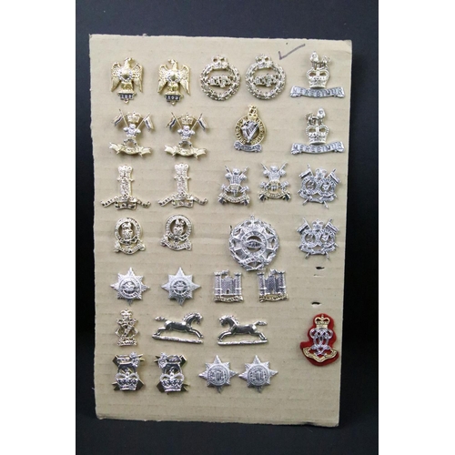 46 - A collection of British military regimental cap and collar badges to include the Lincolnshire regime... 