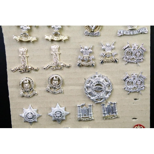 46 - A collection of British military regimental cap and collar badges to include the Lincolnshire regime... 