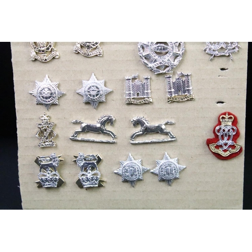 46 - A collection of British military regimental cap and collar badges to include the Lincolnshire regime... 