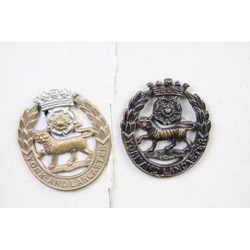 48 - A collection of British military Regimental cap and collar badges to include The West Yorkshire Regi... 