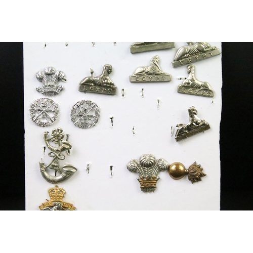 49 - A collection of British military Regimental cap and collar badges to include the East Lancashire Reg... 