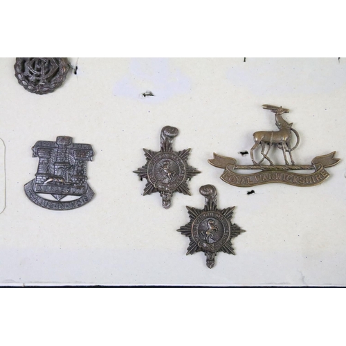 49 - A collection of British military Regimental cap and collar badges to include the East Lancashire Reg... 