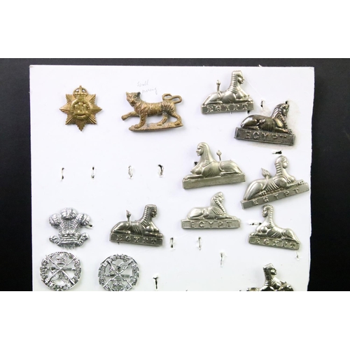 49 - A collection of British military Regimental cap and collar badges to include the East Lancashire Reg... 