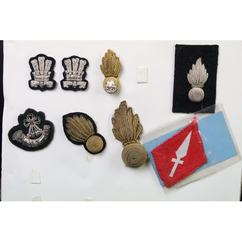 52 - A collection of British Military Cloth badges, trade badges, shoulder titles, buttons and sweetheart... 