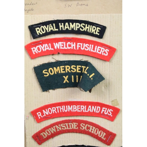 52 - A collection of British Military Cloth badges, trade badges, shoulder titles, buttons and sweetheart... 