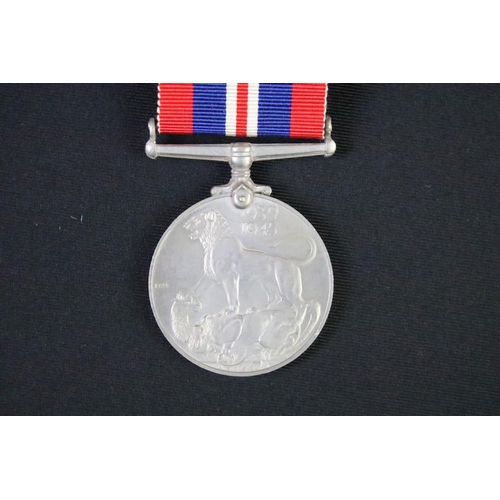 57 - A British World War Two full size medal pair to include the 1939-45 British war medal and the 1939-4... 