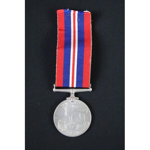 57 - A British World War Two full size medal pair to include the 1939-45 British war medal and the 1939-4... 