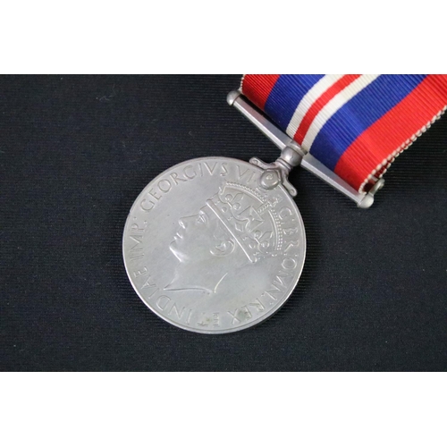 57 - A British World War Two full size medal pair to include the 1939-45 British war medal and the 1939-4... 