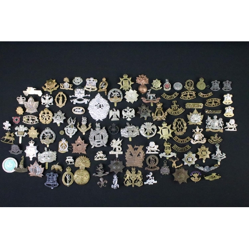 72 - A large collection of mainly British and Commonwealth cap and collar badges to include King Crown an... 