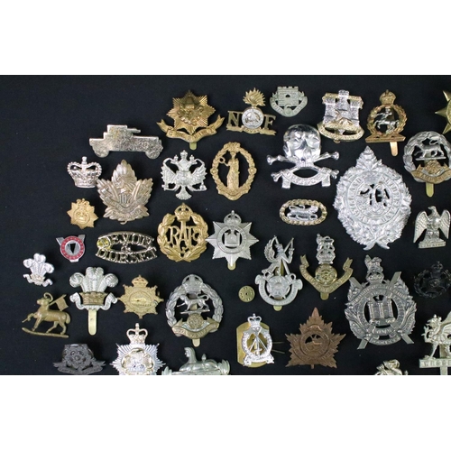 72 - A large collection of mainly British and Commonwealth cap and collar badges to include King Crown an... 