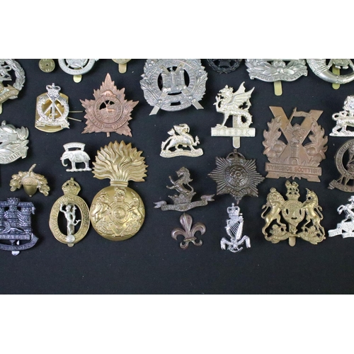 72 - A large collection of mainly British and Commonwealth cap and collar badges to include King Crown an... 