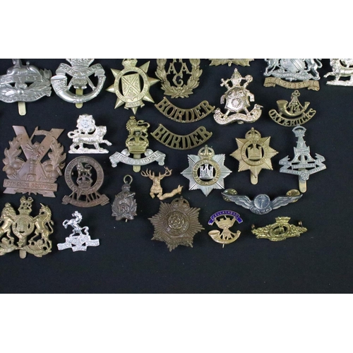 72 - A large collection of mainly British and Commonwealth cap and collar badges to include King Crown an... 