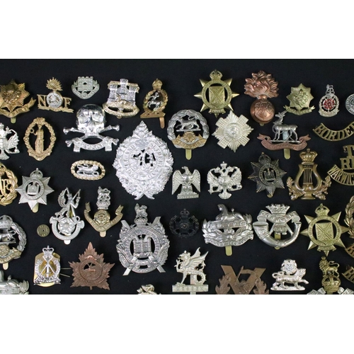 72 - A large collection of mainly British and Commonwealth cap and collar badges to include King Crown an... 