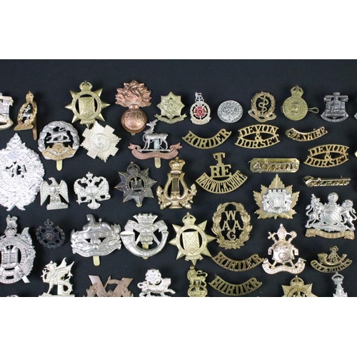 72 - A large collection of mainly British and Commonwealth cap and collar badges to include King Crown an... 