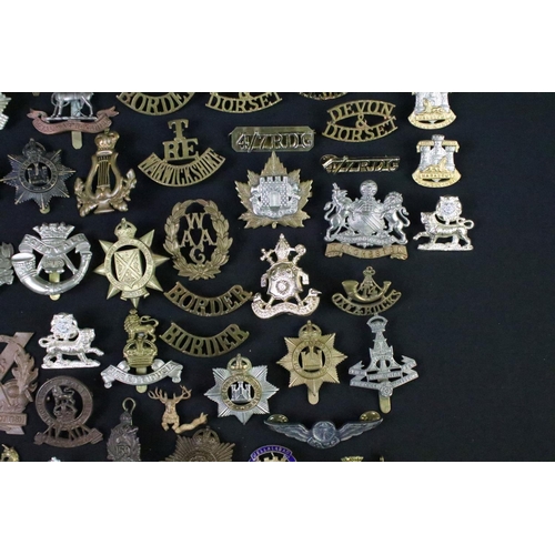 72 - A large collection of mainly British and Commonwealth cap and collar badges to include King Crown an... 