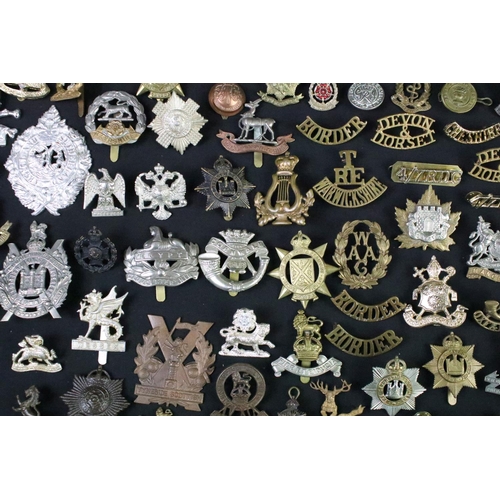 72 - A large collection of mainly British and Commonwealth cap and collar badges to include King Crown an... 