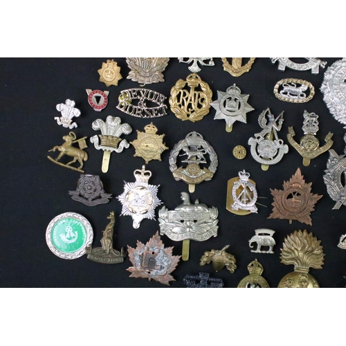 72 - A large collection of mainly British and Commonwealth cap and collar badges to include King Crown an... 