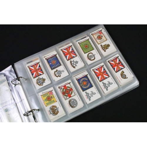 75 - A collection of mixed military collectables to include cloth badges, shoulder titles, lanyards, ciga... 