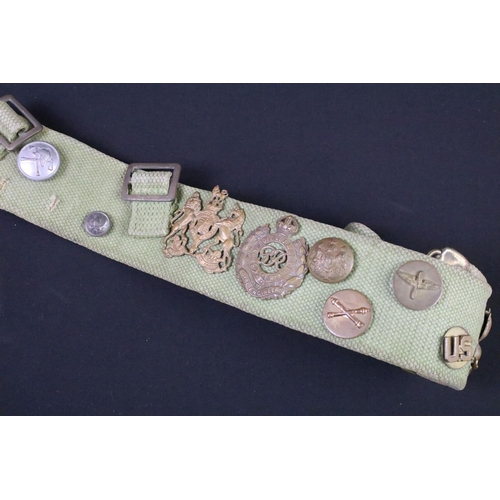 76 - A military webbing belt with attached buttons and cap badges.