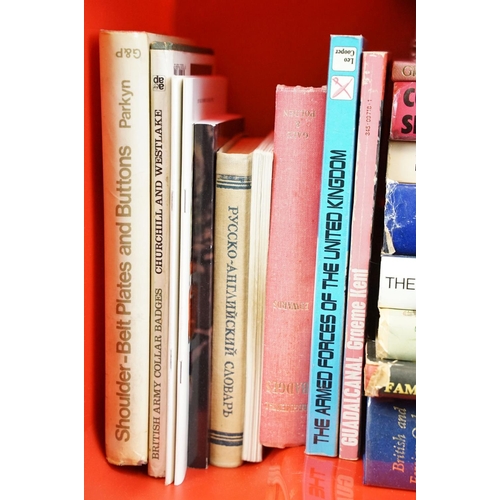 236 - A large collection of military reference books to include Badge, Button, Medal and sword examples.